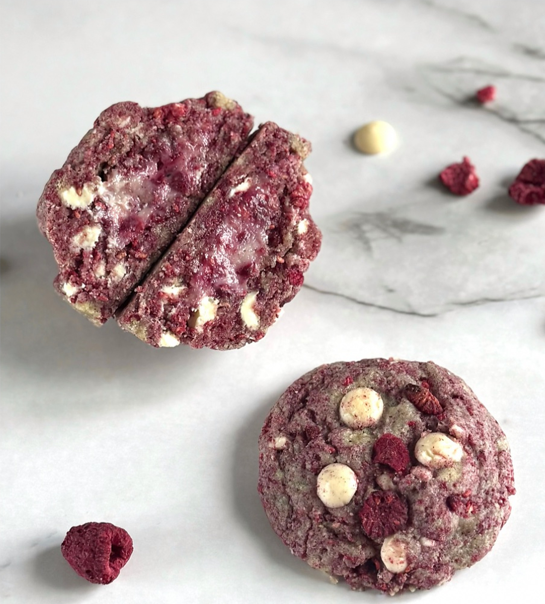 Raspberry and white chocolate cookies, one cut open